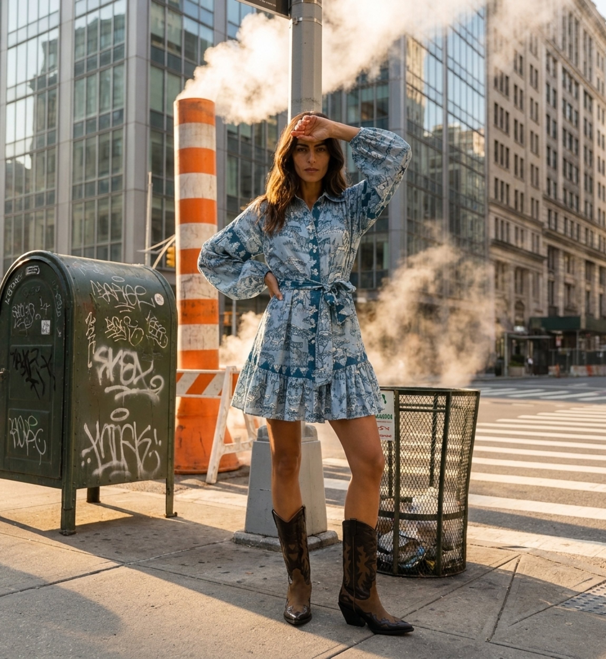 Light blue teal shirtdress with safari toile pattern, long balloon sleeves, collared, tie waist, ruffled hem.