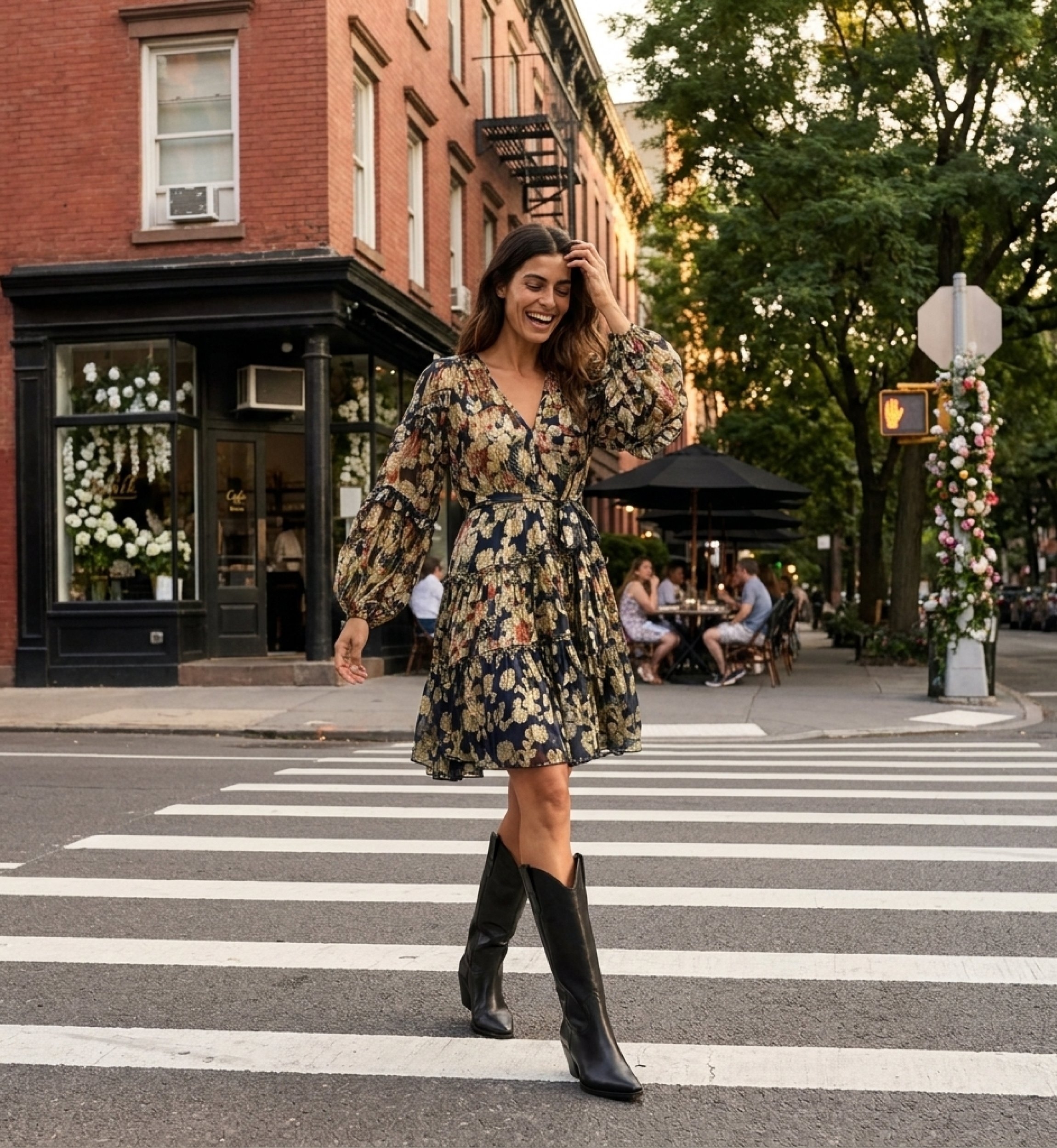 Navy blue floral short-sleeve V-neck dress with tiered skirt and tie waist, sheer fabric, styled outdoors at a cafe.