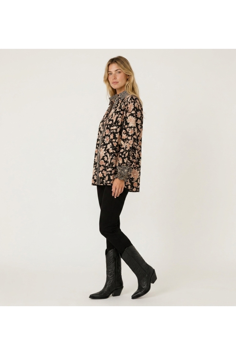 Black long-sleeve floral blouse with cream and rust pattern, collared neckline, ruffled cuffs, lightweight fabric, three-quarter