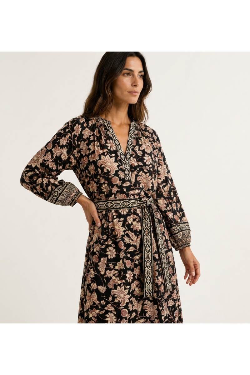 Three-quarter view of a black floral midi dress with V-neck, long balloon sleeves, and tie-waist belt.