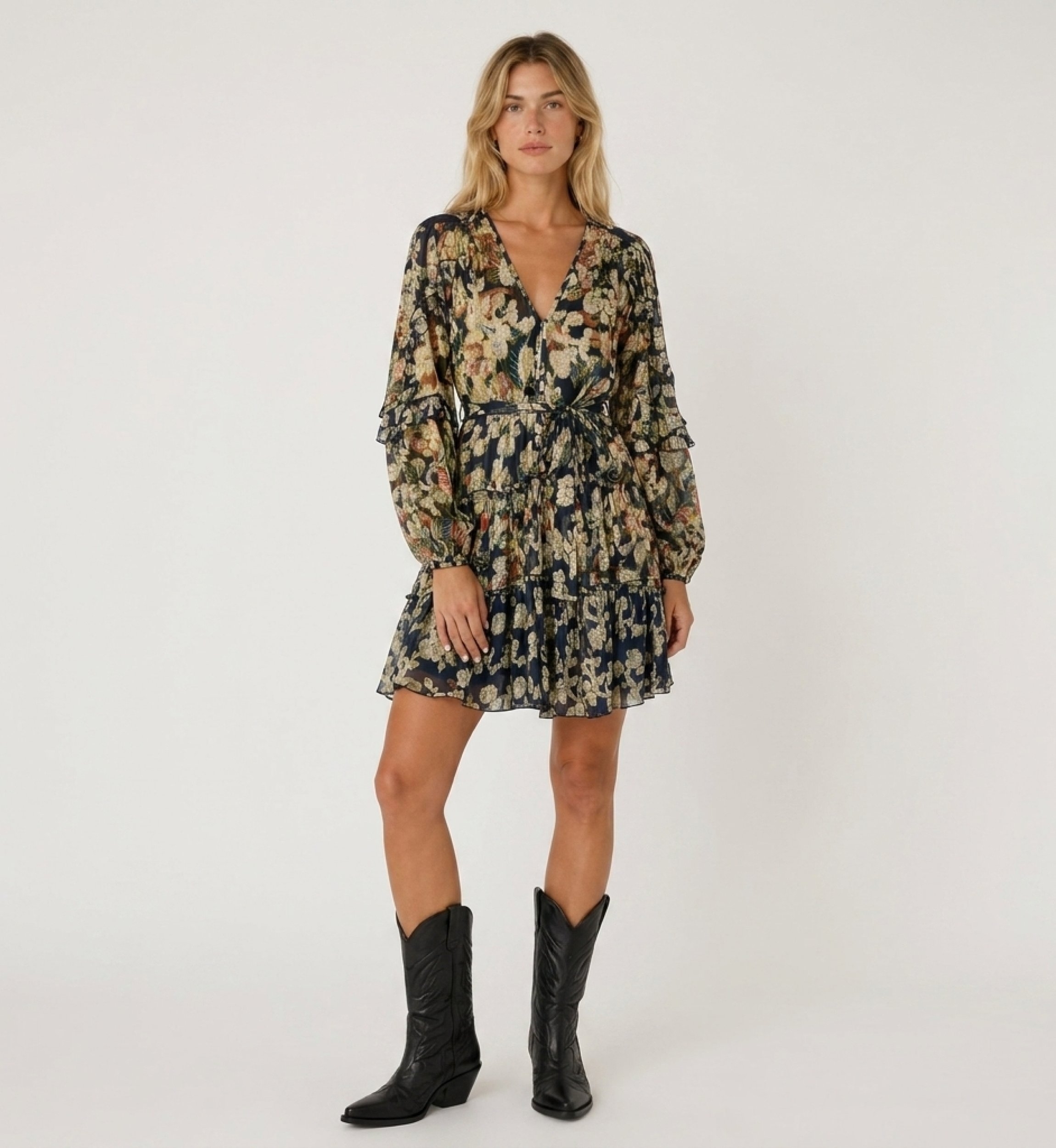 Front view of a navy blue short-sleeved V-neck dress with gold floral pattern, tiered skirt, and tie waist.