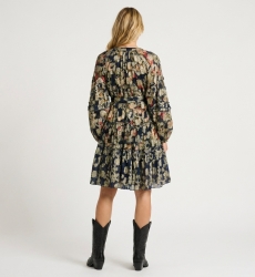 Back of navy blue short sleeve floral dress, gold pattern, V-neck, tiered skirt, tie waist, lightweight sheer.