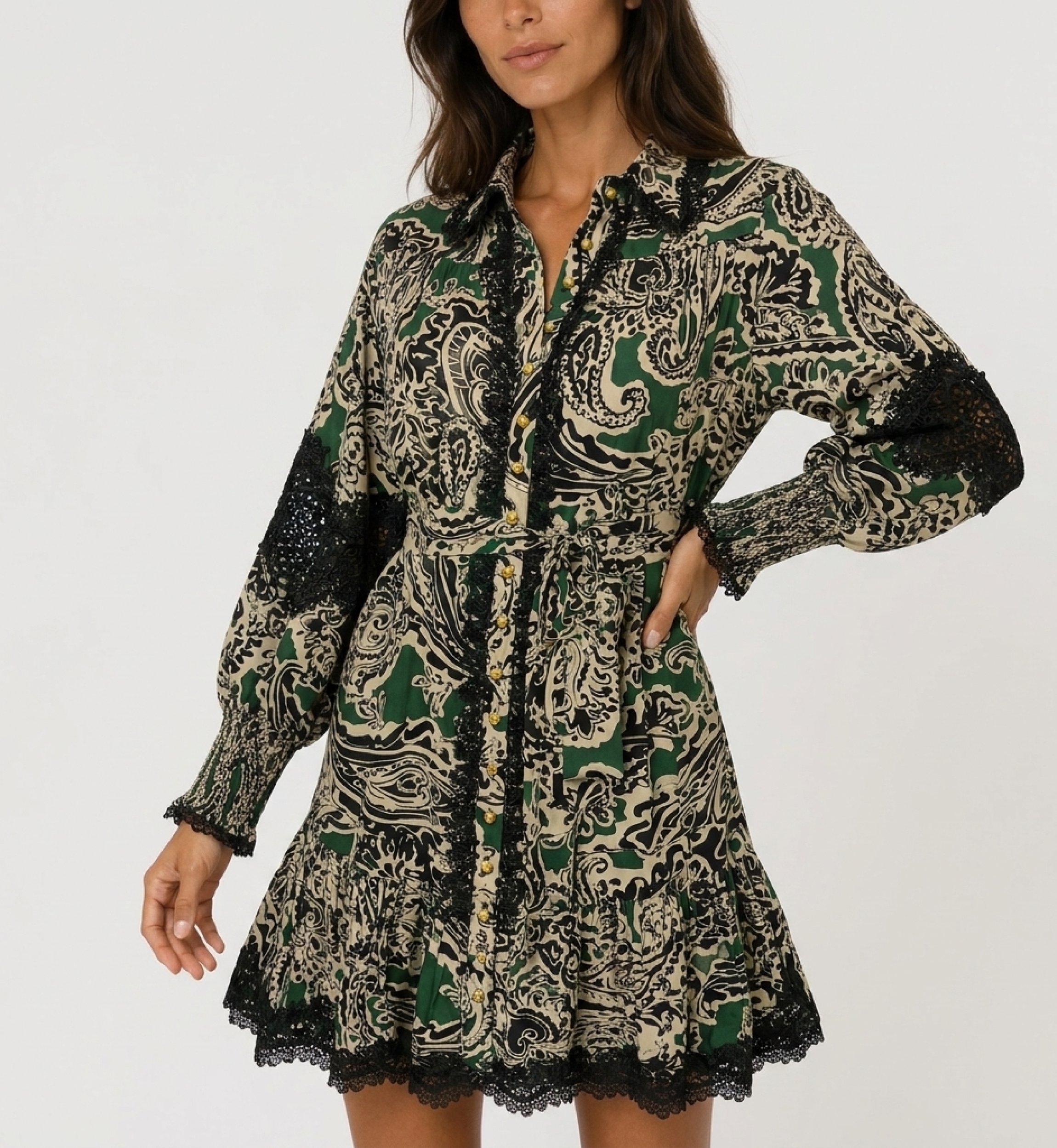 Green, black, beige paisley mini dress, long-sleeve, collared, with black lace trim, gold buttons, and tie waist.