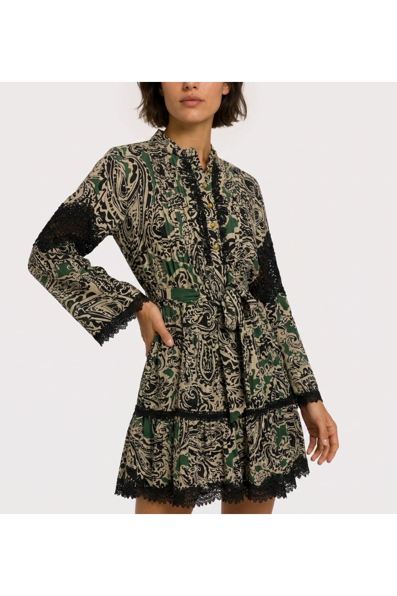 Green, black, beige paisley mini-dress. Long-sleeve, collared, tiered skirt, tie-waist, black lace trim. Three-quarter view.