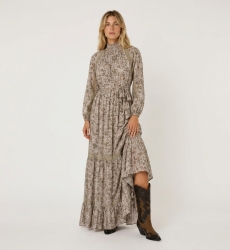 Front view of a light pink floral maxi dress with green gold leaf patterns, high smocked neck, puff sleeves, and lace trim.