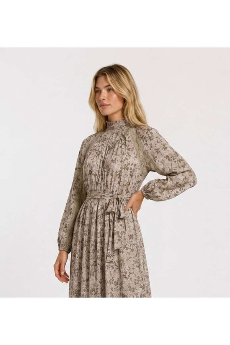 Light pink floral maxi dress, green gold leaf pattern. High smocked neck, long puff sleeves, lace trim. Three-quarter side view.