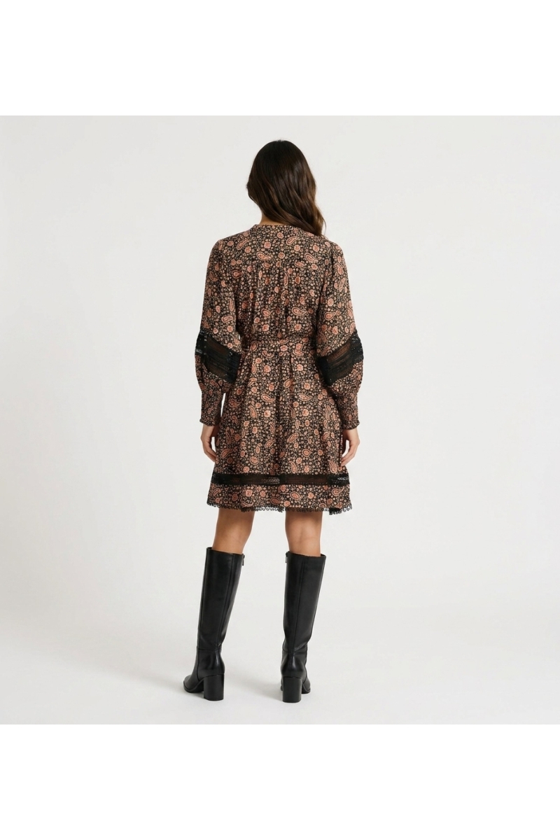 Back view of a black and pink paisley floral print mini dress with long puff sleeves, collared V-neck, and lace trim.