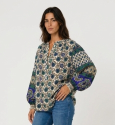 Cream long-sleeve blouse with blue green floral print. Lightweight fabric, contrasting balloon sleeves. Three-quarter view.