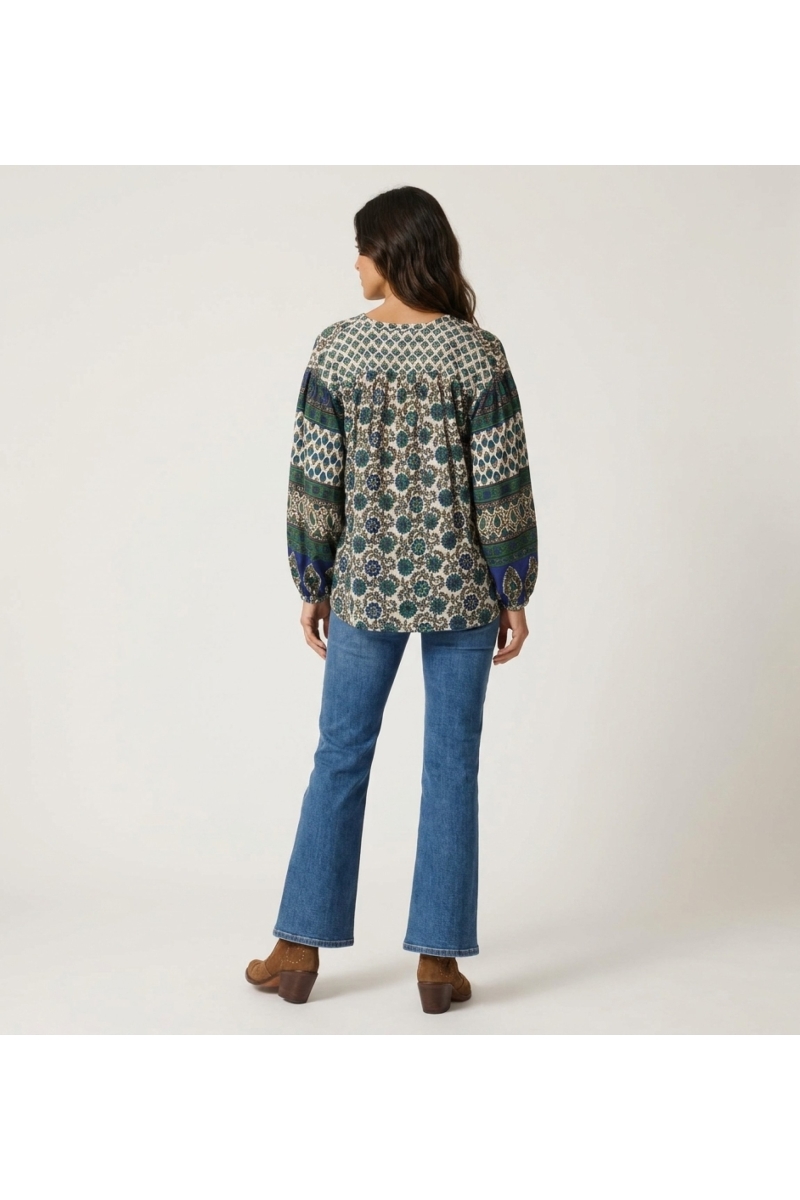 Women's long sleeve cream blouse with blue and green floral pattern, contrasting balloon sleeves, back view.