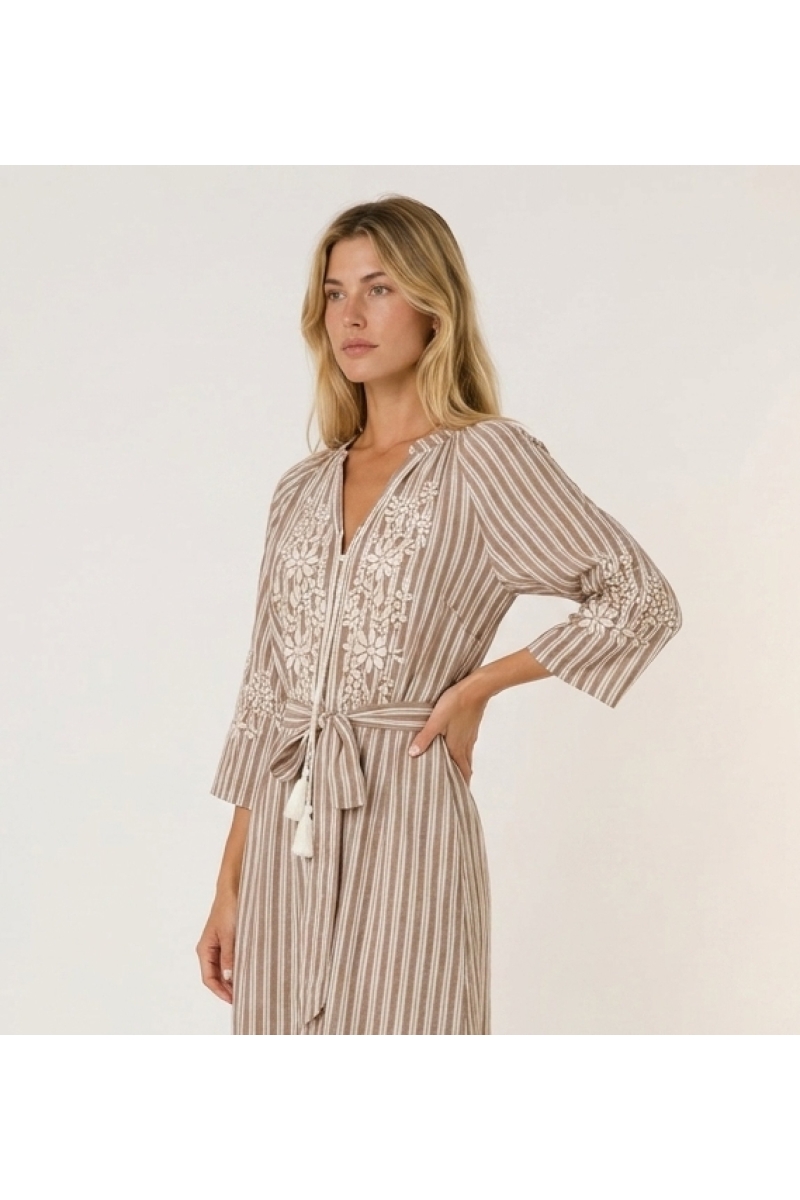 Brown and white striped midi dress with tiered skirt, white floral embroidery, and tie waist with tassels, three-quarter side vi