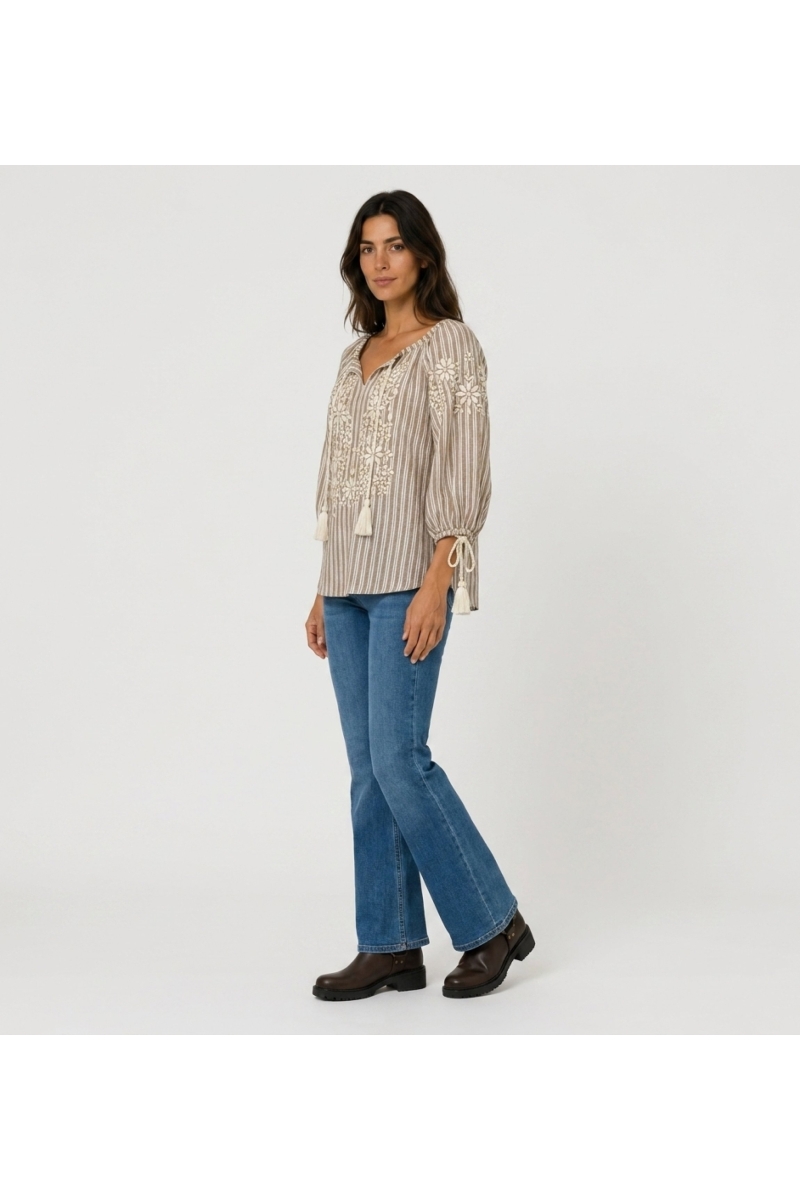 Brown and white striped peasant blouse with V-neck, three-quarter balloon sleeves, floral embroidery, tassels. Three-quarter sid