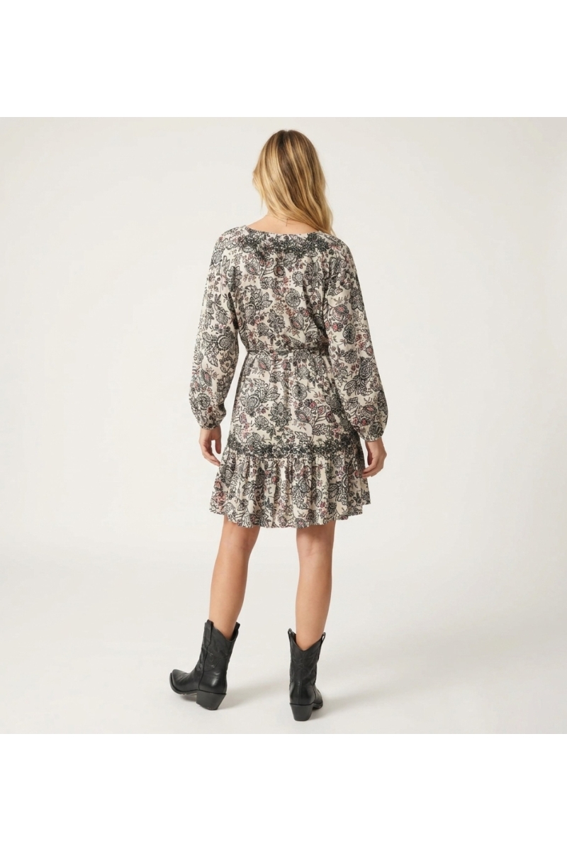 Cream long-sleeve V-neck mini-dress with black and red paisley pattern, tiered skirt, tie-waist, lightweight fabric, back view.