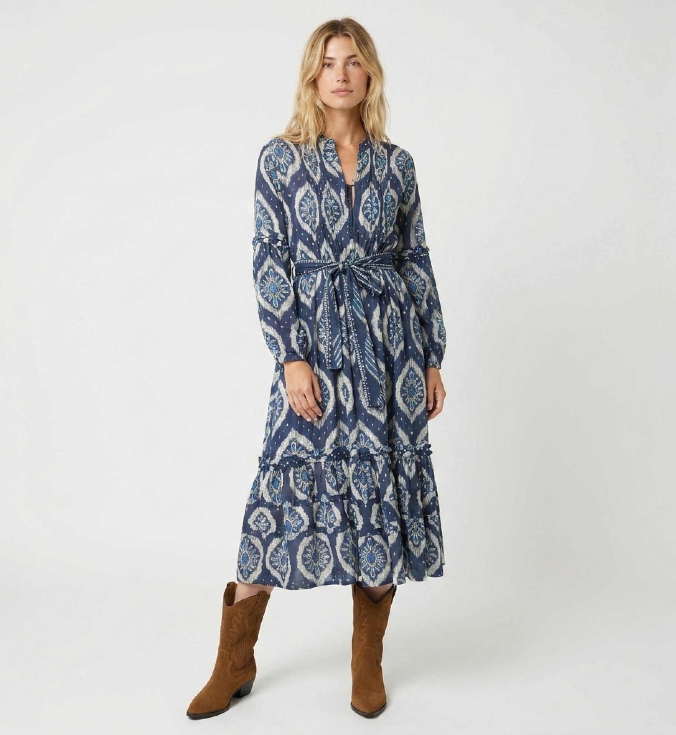 Vestido midi azul y blanco estampado ikat, mangas largas abullonadas, falda escalonada, cinturón de lazo.