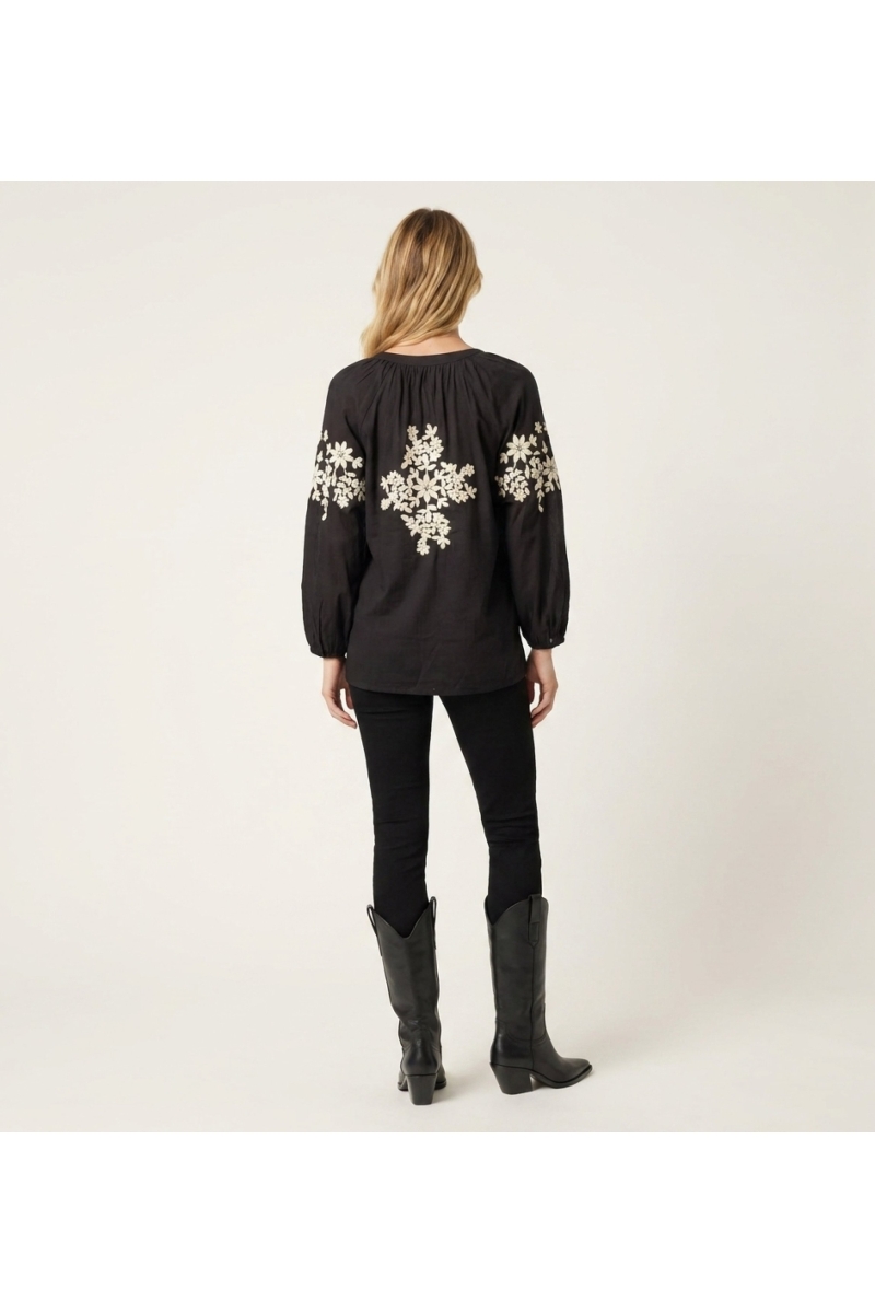Black long-sleeve linen-blend peasant blouse with cream floral embroidery, detailed back view.