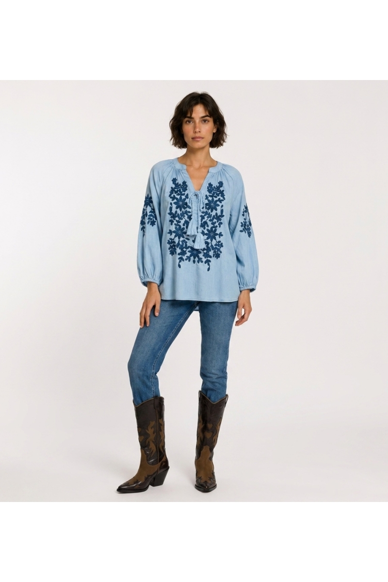 Front view of a black long-sleeve peasant blouse with v-neck, tie closure, and cream floral embroidery. Linen-look fabric.