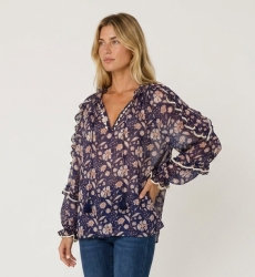 Sheer navy blue floral blouse with white and peach print, ruffled long sleeves, V-neck with ties, loose fit, three-quarter view.