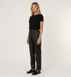 Women's black leather pants, slim fit, shown from a three-quarter side view, highlighting the cut and texture.