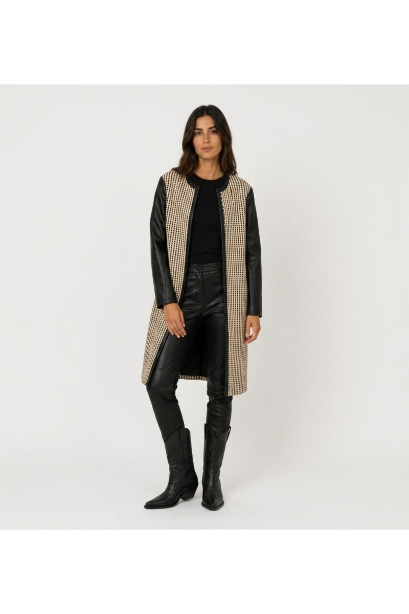 Front view of a collarless, open-front long jacket in black and beige woven fabric with faux leather sleeves.