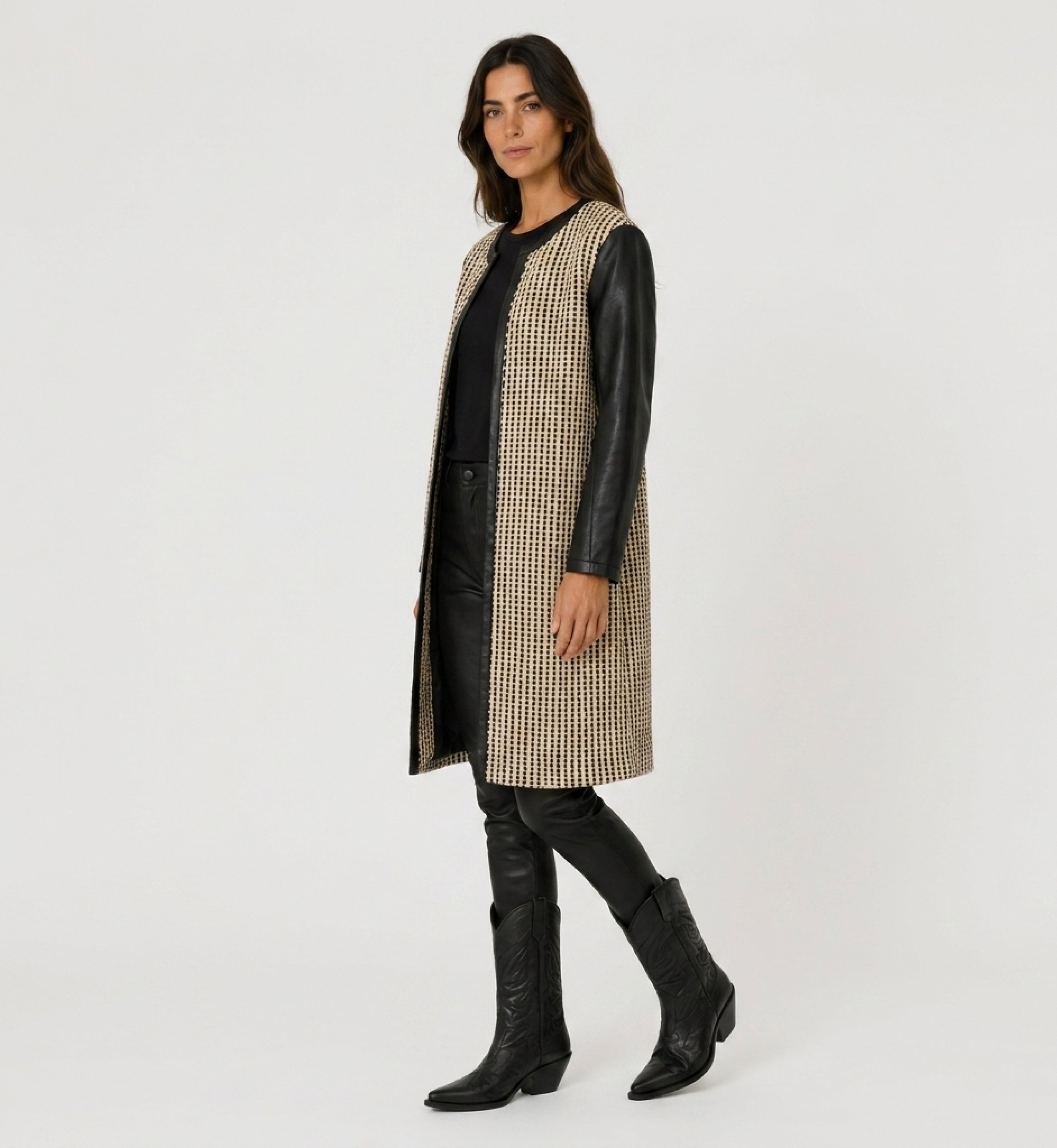 Collarless long jacket, black and beige woven fabric, open-front, with black faux leather sleeves and trim, three-quarter view.