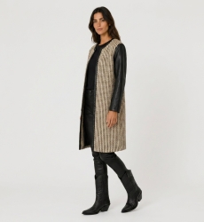 Collarless long jacket, black and beige woven fabric, open-front, with black faux leather sleeves and trim, three-quarter view.